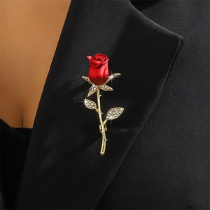 Elegant red rose brooch with gold metal leaves and sparkling rhinestones on black suit