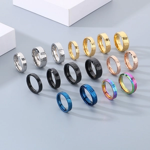 Macro detail of multi-colored hammered texture stainless steel rings in varied finishes