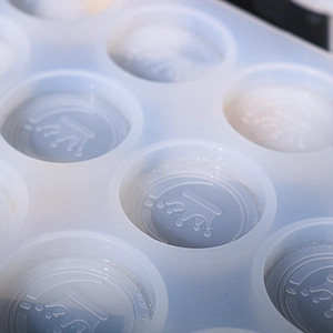 Close-up of translucent white silicone mold with embossed crown patterns for DIY resin crafts