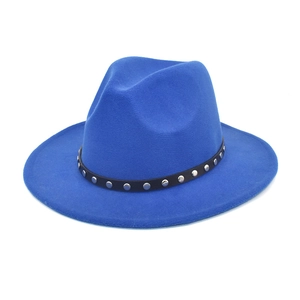 Close-up of blue wool fedora hat featuring a black decorative band with silver metal studs