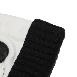 Détail de la polaire blanche douce et du bord en tricot noir du bonnet de panda