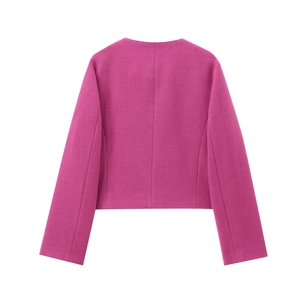 Detail of vibrant rose pink cropped blazer showing textured fabric and clean round neckline