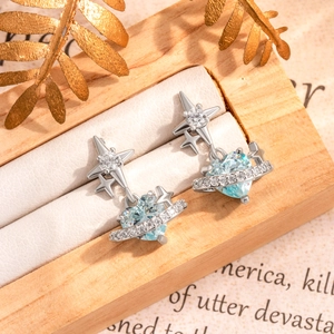 Blue star and heart titanium steel ear stud displayed on a jewelry box cushion