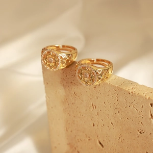 Detail of vintage style open rings with hollow geometric patterns and zircon inlay