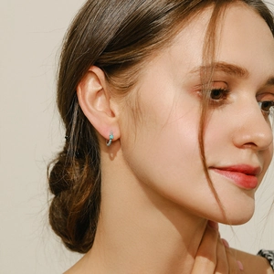 S925 sterling silver hoop earrings with blue turquoise stones worn by a model