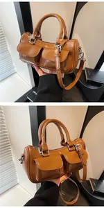 Detail of caramel brown Boston bag showing dual cargo pockets and polished silver buckles