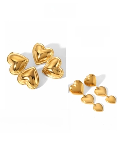 Detailed view of polished 18k gold-plated heart studs and dangling heart earrings