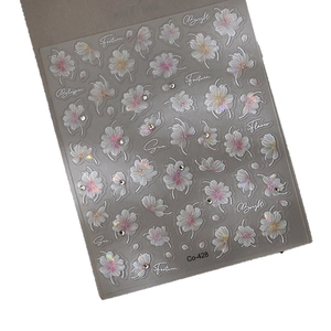 3D embossed cherry blossom nail art stickers with white floral patterns and crystal gems