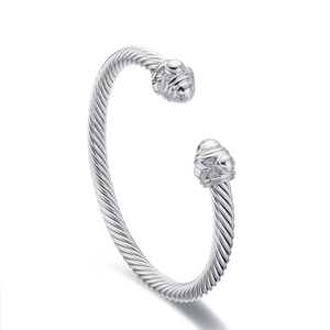 Silver twisted cable open cuff bracelet with vintage engraved ball end caps on white background