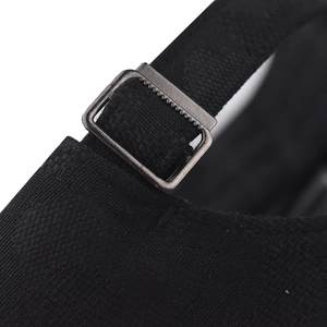 Detailed close-up of the adjustable metal buckle and black strap on the camouflage baseball cap