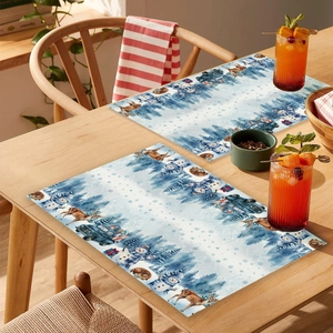 Christmas placemats featuring snowmen and reindeer on a warm wooden dining table