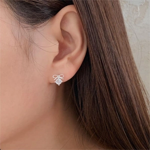 925 sterling silver bow knot stud earrings with round zircon stones on female ear