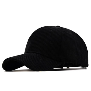 Detailed close-up of black corduroy baseball cap texture and six-panel structure