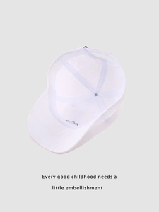 Detail showing inner mesh lining and reinforced stitching of a white kids baseball cap
