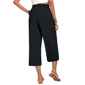 Detail view of the elastic high waist and pleated back of black linen wide leg trousers