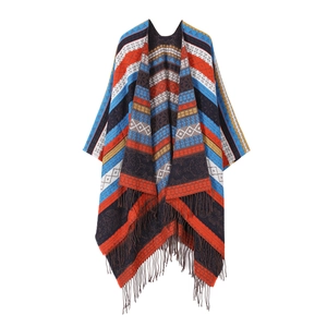 Ethnic knit poncho with geometric diamond patterns and orange fringe tassels