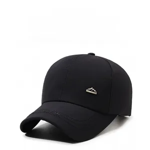 Detail of black baseball cap showing mountain logo and curved brim embroidery