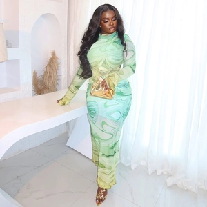 Detail of elegant green marble print dress with long sleeves and slim fit silhouette