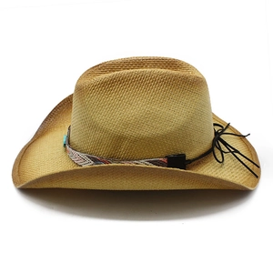 Detail of hand-woven straw cowboy hat featuring ethnic pattern band and turquoise bead
