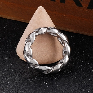 Close-up of a silver Cuban link chain ring with intricate woven texture and metallic luster