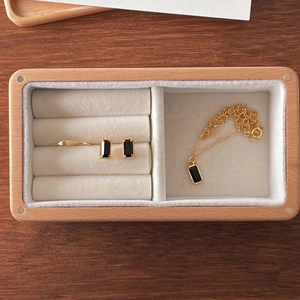 Detailed macro view of a rectangular wooden jewelry box with soft velvet lining and ring slots