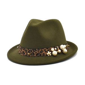 Detail of dark green wool felt fedora featuring leopard trim and pearl embellishments