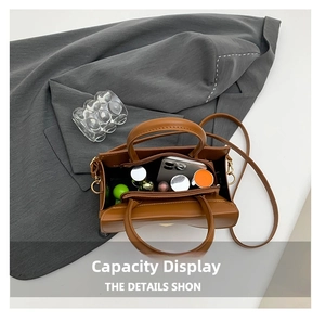 Spacious interior of brown crocodile pattern bag showing phone and cosmetics storage