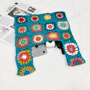Detail of colorful granny square crochet tote bag showing interior storage and knit texture