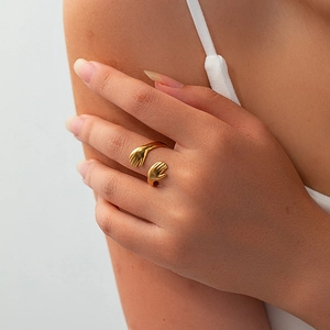 Detailed view of an 18K gold hug hands open ring in stainless steel worn on a finger