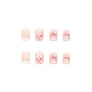 Pink press-on nails with white cherry blossom patterns and silver glitter French tips