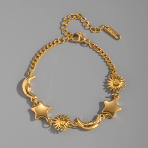 Close-up of gold stainless steel bracelet featuring sun, moon, and star charms detail
