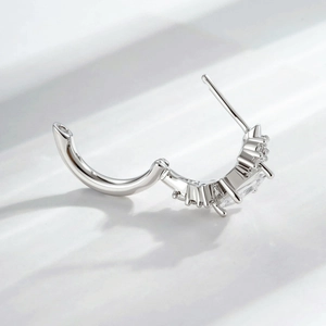 Silver hinged hoop earrings with square and round clusters of clear cubic zirconia
