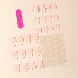 Almond white French press-on nails set with pearls, bows, nail file, and adhesive tabs