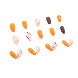 Vibrant orange and coffee almond press-on nails with golden glitter ribbon accents