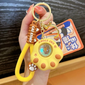 Creative yellow cat paw keychain with sunset lamp effect and a stylish wrist strap