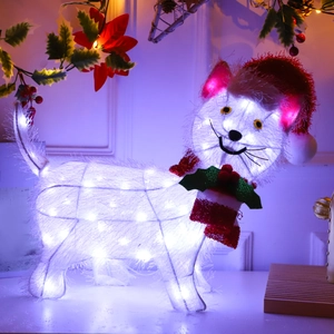Detail of a Christmas light-up Dachshund dog figure with a festive red hat and bowtie