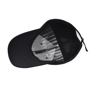 Detail view of the interior construction and adjustable metal buckle on a black baseball cap