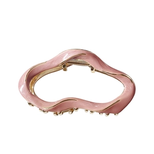 Pink marble texture large metal hair claw clip with irregular wave design on white background