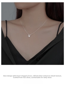 Close-up of S925 sterling silver bow necklace with heart-shaped cubic zirconia pendant