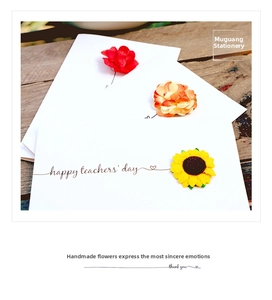 Detail showing 3D handmade sunflower and rose bouquet cards on a dark wood texture surface