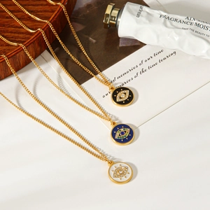 Detail of gold evil eye pendant necklaces with blue enamel on a warm wooden tray