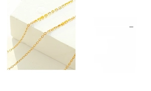 Detailed close-up of 18K gold plated stainless steel O-chain necklace on a white stone