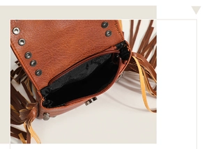 Detail of brown faux leather crossbody bag with metal rivets and magnetic snap closure