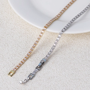 Macro detail of gold and silver tennis bracelets with double row rectangular zircons