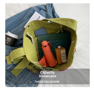 Green canvas tote bag interior showing large capacity with tablet and daily essentials