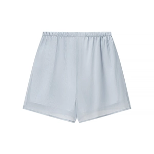 Detailed view of light blue elastic waistband shorts with breathable textured fabric