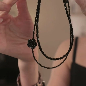 Detail of double-layer black crystal beaded necklace with gothic rose flower pendant