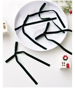 Close-up of handmade dark green velvet bows for Christmas tree and DIY gift wrapping