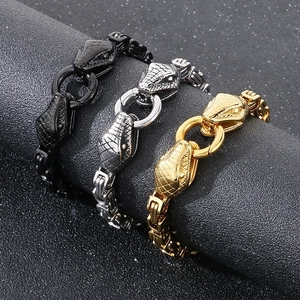 Three-color stainless steel snake head bracelets with curb chains on display