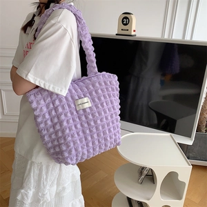 Detail of light purple bubble texture tote bag with LOVE SOZAKKA woven label on shoulder